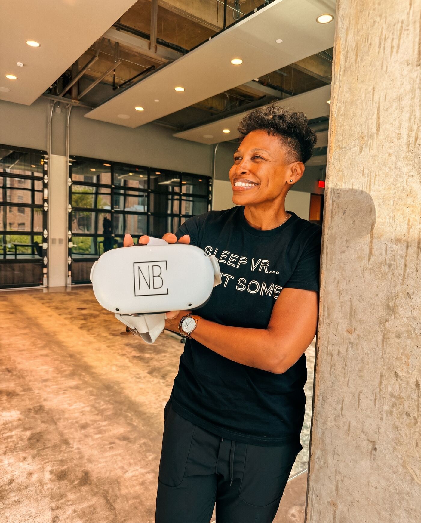 Khaliah Guillory holding a VR headset in a modern building