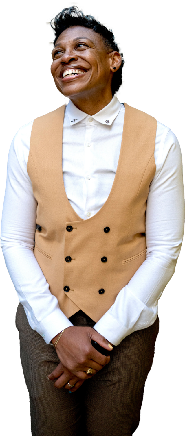 Khaliah O. Guillory smiling, in a camel vest