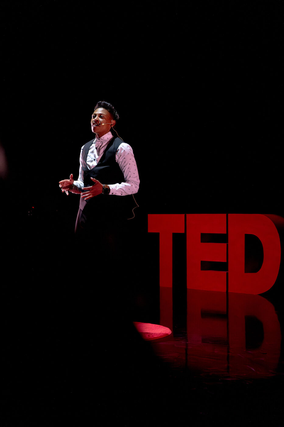 Khaliah O. Guillory speaking beside the red TEDx letters