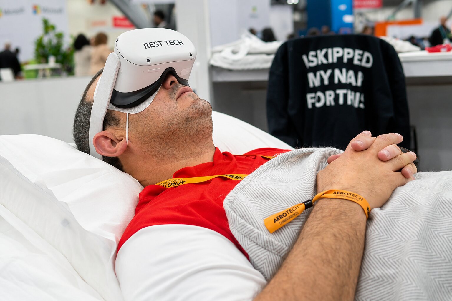 A reclining event participant wearing a Rest Tech virtual reality headset.