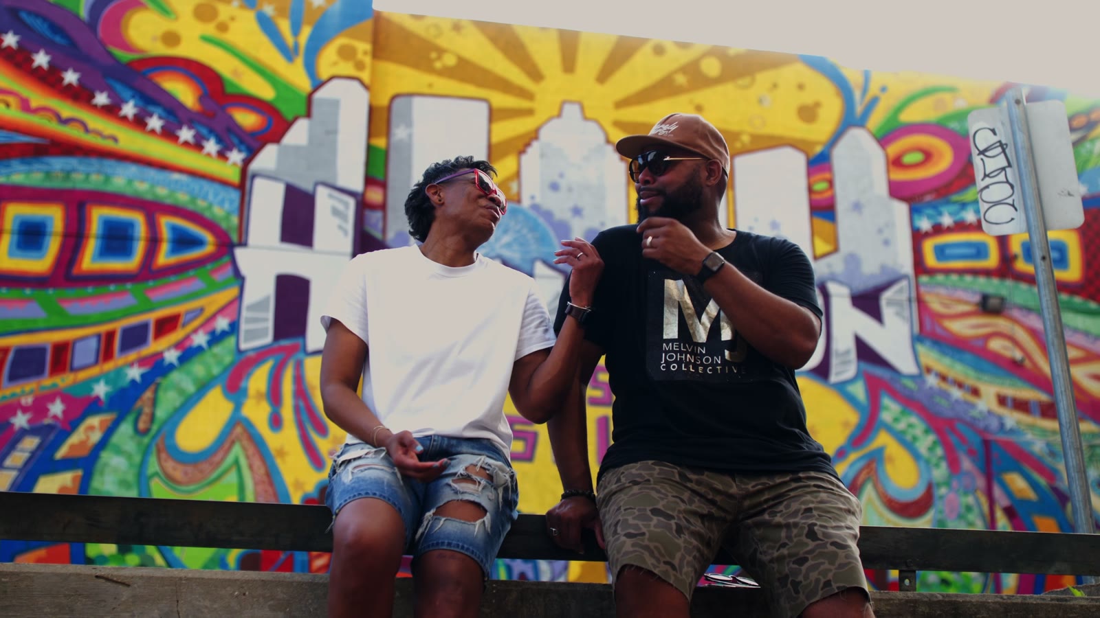 Khaliah G and Melvin Johnson in front of a Houston mural in the Get Up music video