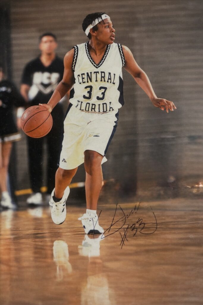 Khaliah Guillory in her Central Florida #33 jersey driving the basketball, college era